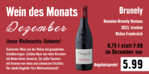 Werbung für den Wein des Monats Dezember mit einer Flasche Domaine Brunely Ventoux 2023, trocken, aus der Rhône in Frankreich. Der Text beschreibt den Wein als rubinrot mit granatroten Schattierungen, Noten von roten Kirschen und Gewürzen. Er wird als idealer Begleiter für Weihnachtsmenüs empfohlen, zum Sonderpreis von 5,99 Euro anstatt 7,99 Euro für 0,75 Liter.